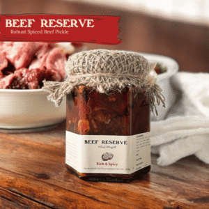 Glass jar of Spiso Beef Preserve with burlap lid on a light surface with a bowl of beef pickle
